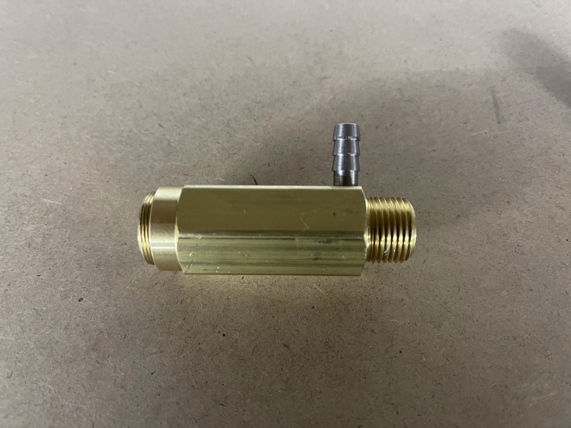 Side view of General Pump 100723 safety relief valve body with 3/8-inch NPT threads