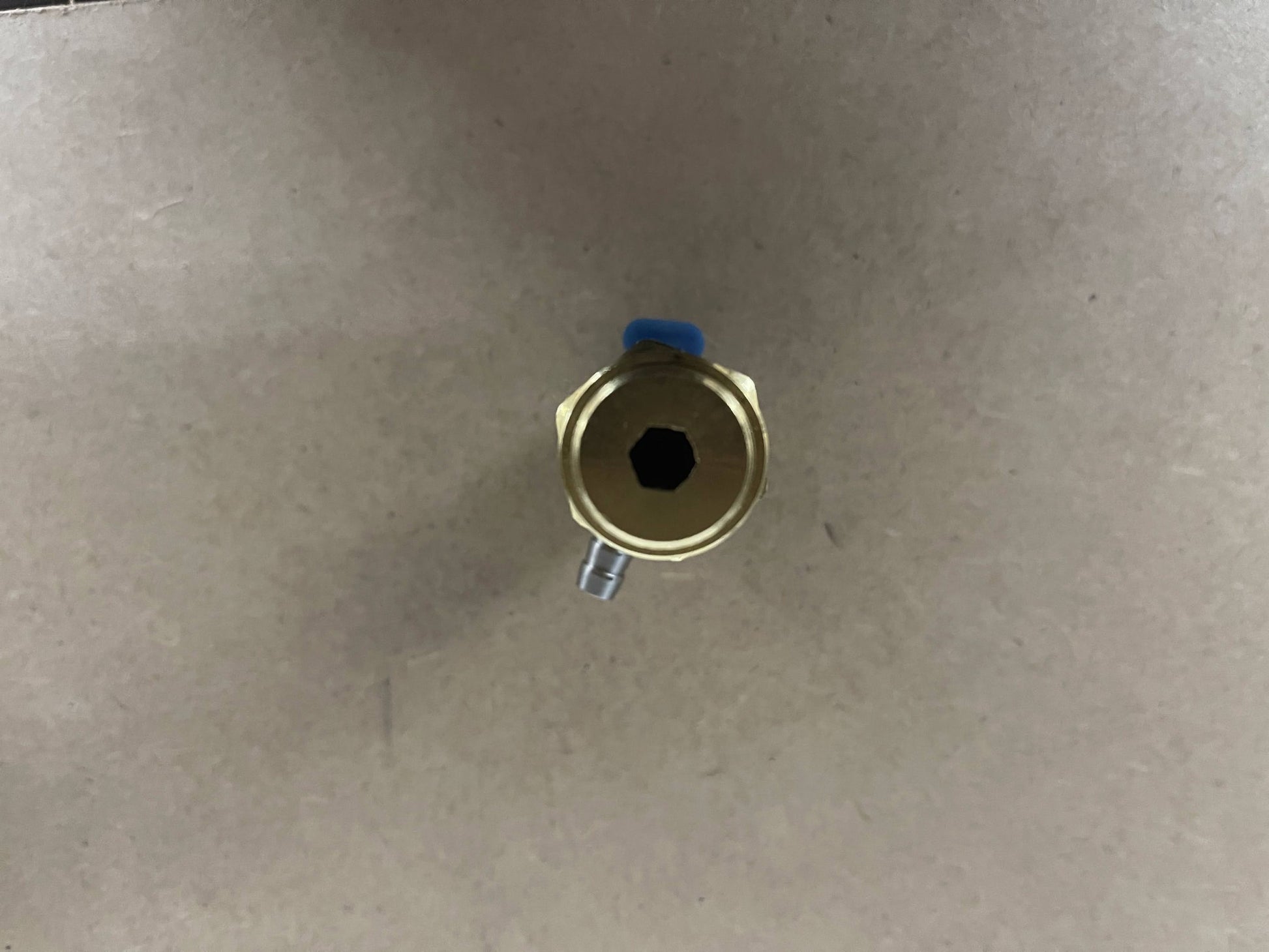 Top view of General Pump 100723 safety relief valve hex adjustment cap with hose barb