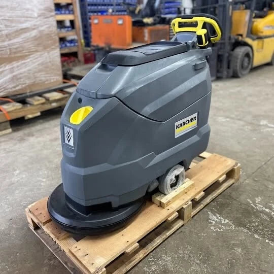 Karcher BD 50/50 C Bp Classic floor scrubber on a wooden pallet in a warehouse