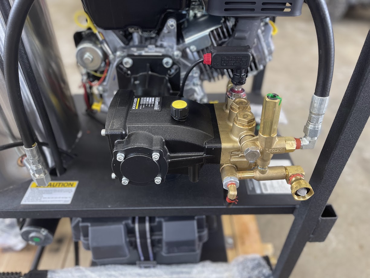 Close-up of the Karcher pump, unloader valve, and brass fittings on the pressure washer