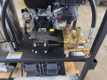 Close-up of the Karcher pump, unloader valve, and brass fittings on the pressure washer