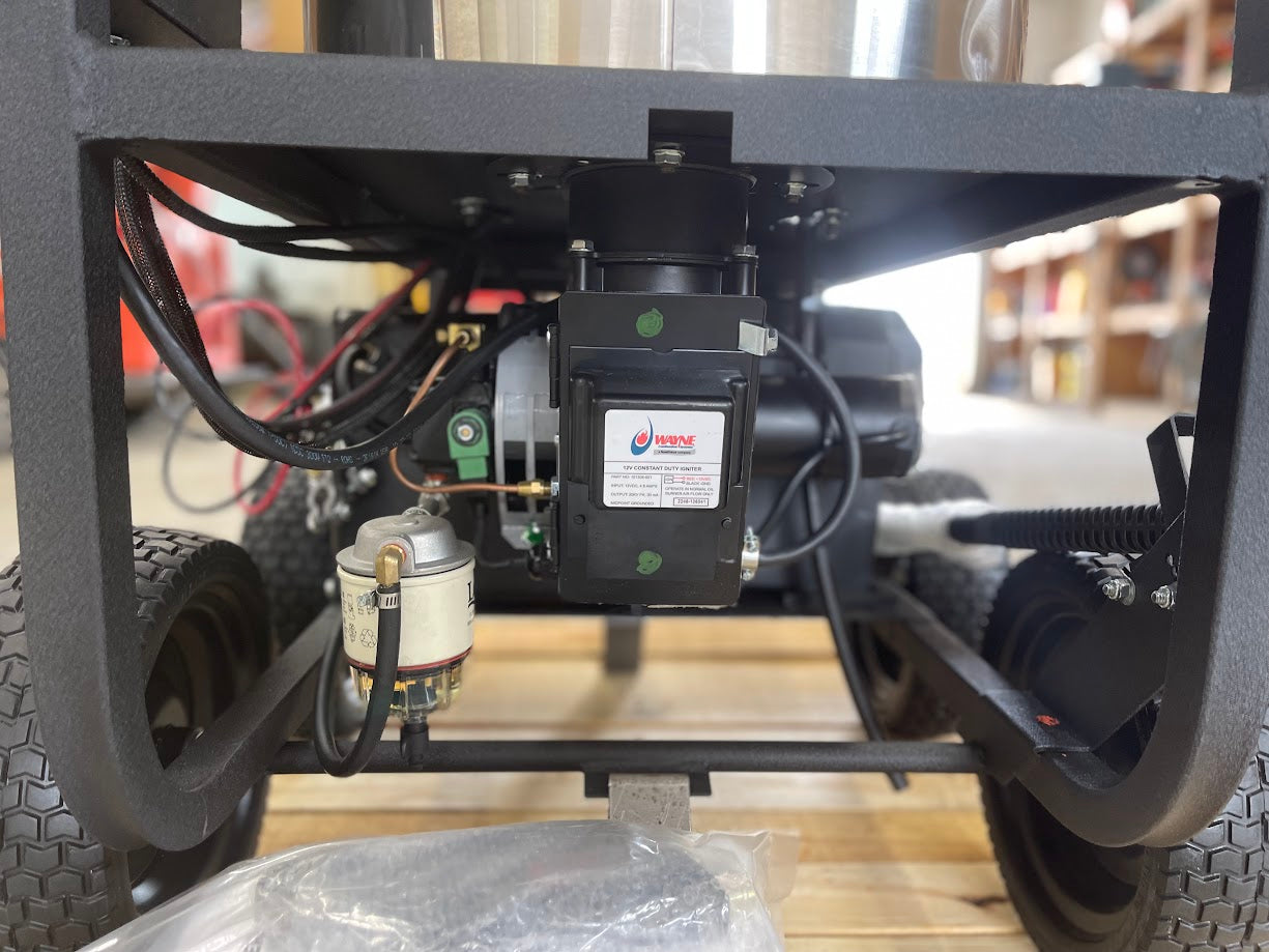 Rear underside view of the Karcher pressure washer showing burner ignitor motor, fuel filter, and wiring