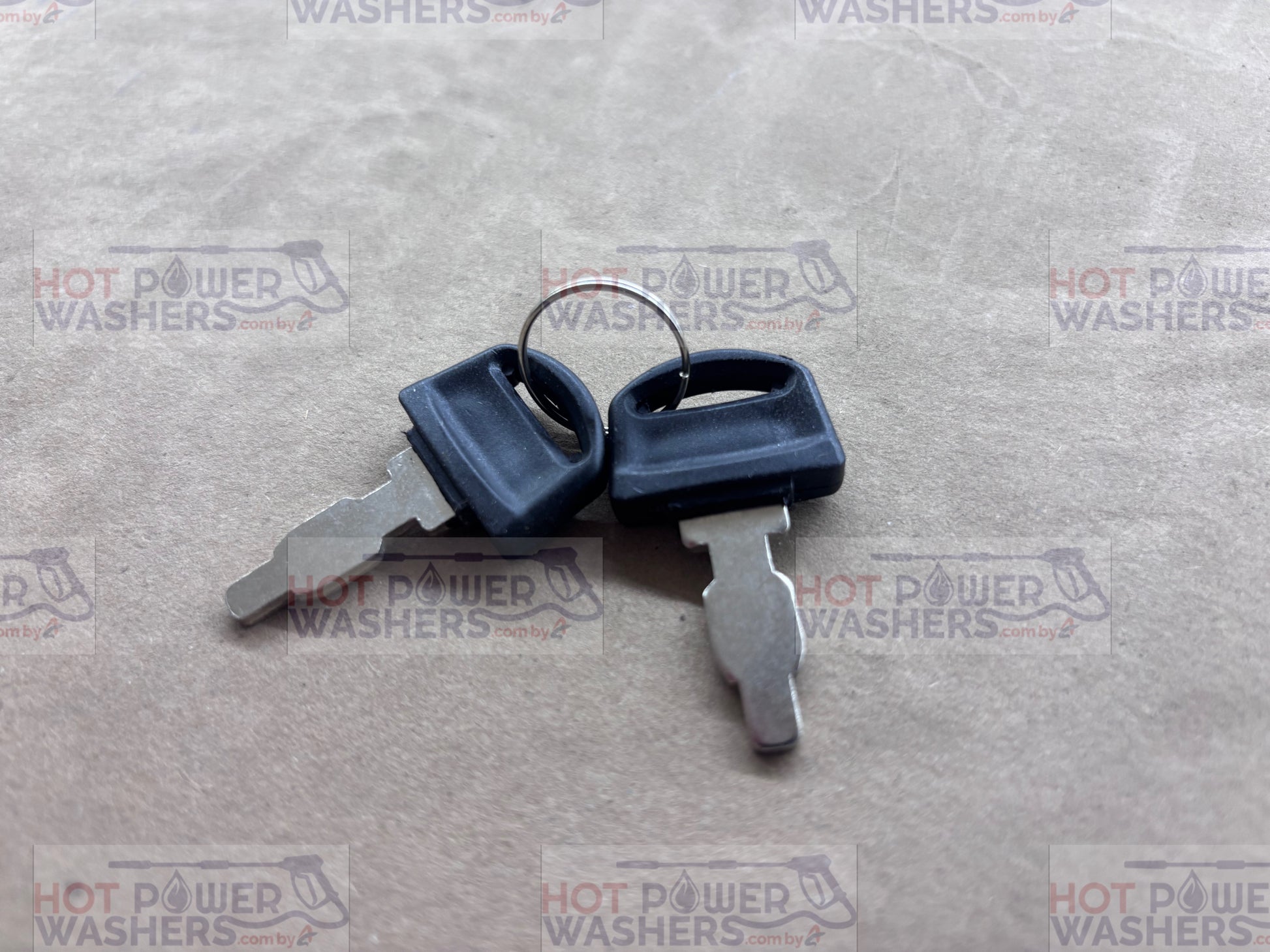 Two included keys for the Lifan ignition switch box on a gray textured surface